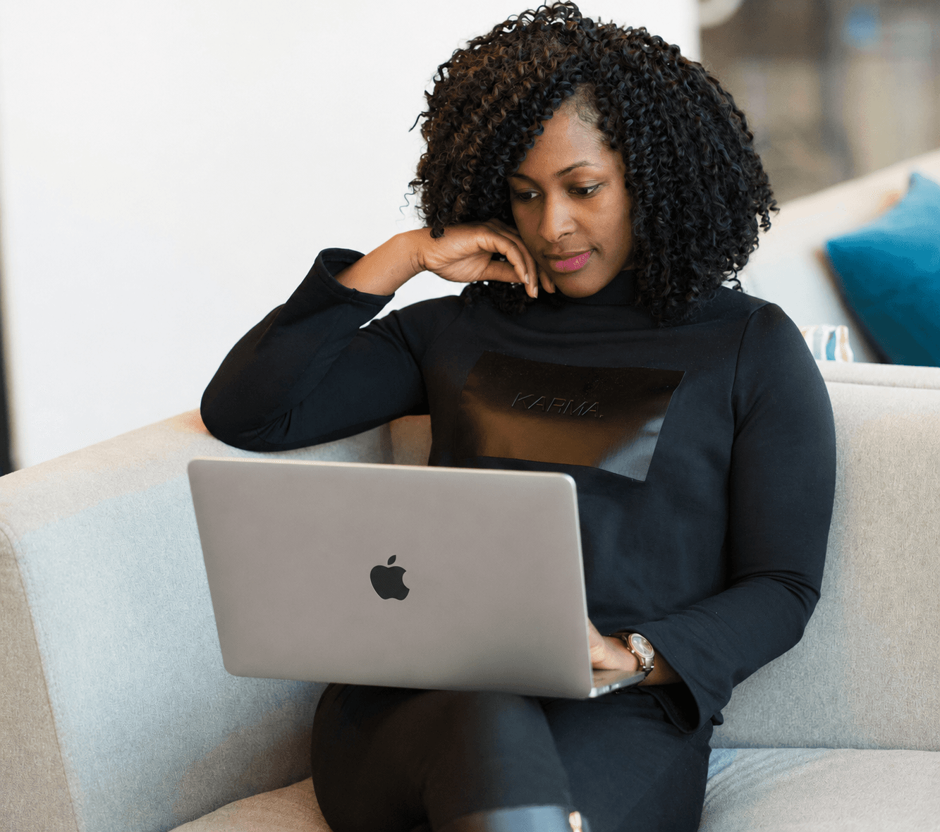AltE executive assistant working on a laptop in a modern office lounge
